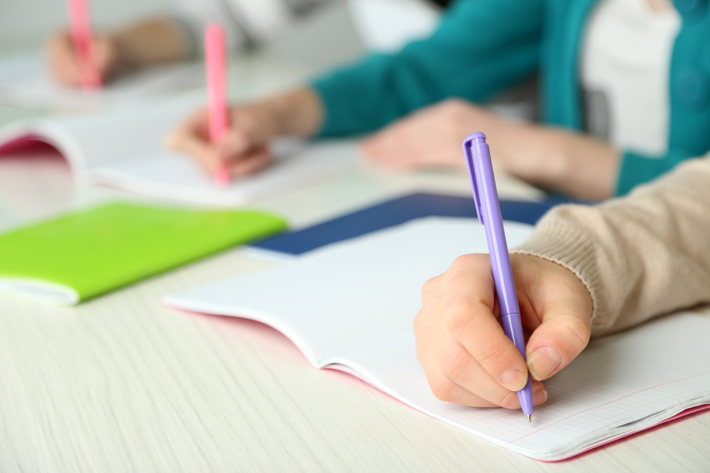 Hands of Students Writing